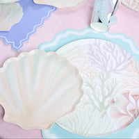 seashell dessert plates with mermaid party setup and pastel tableware.
