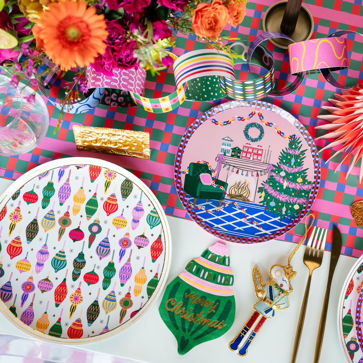 Overhead Season of Cheer tablescape showing the ornament napkins with patterned plates, florals, and vibrant holiday décor.