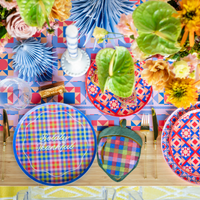 Styled Season of Cheer fall tablescape showing the plaid acorn napkins with plaid plates, paper fans, greenery, and vibrant autumn décor.