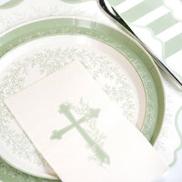 A curated Secret Garden table setting featuring Botanical Cross napkins and sage green lattice-edge plates.