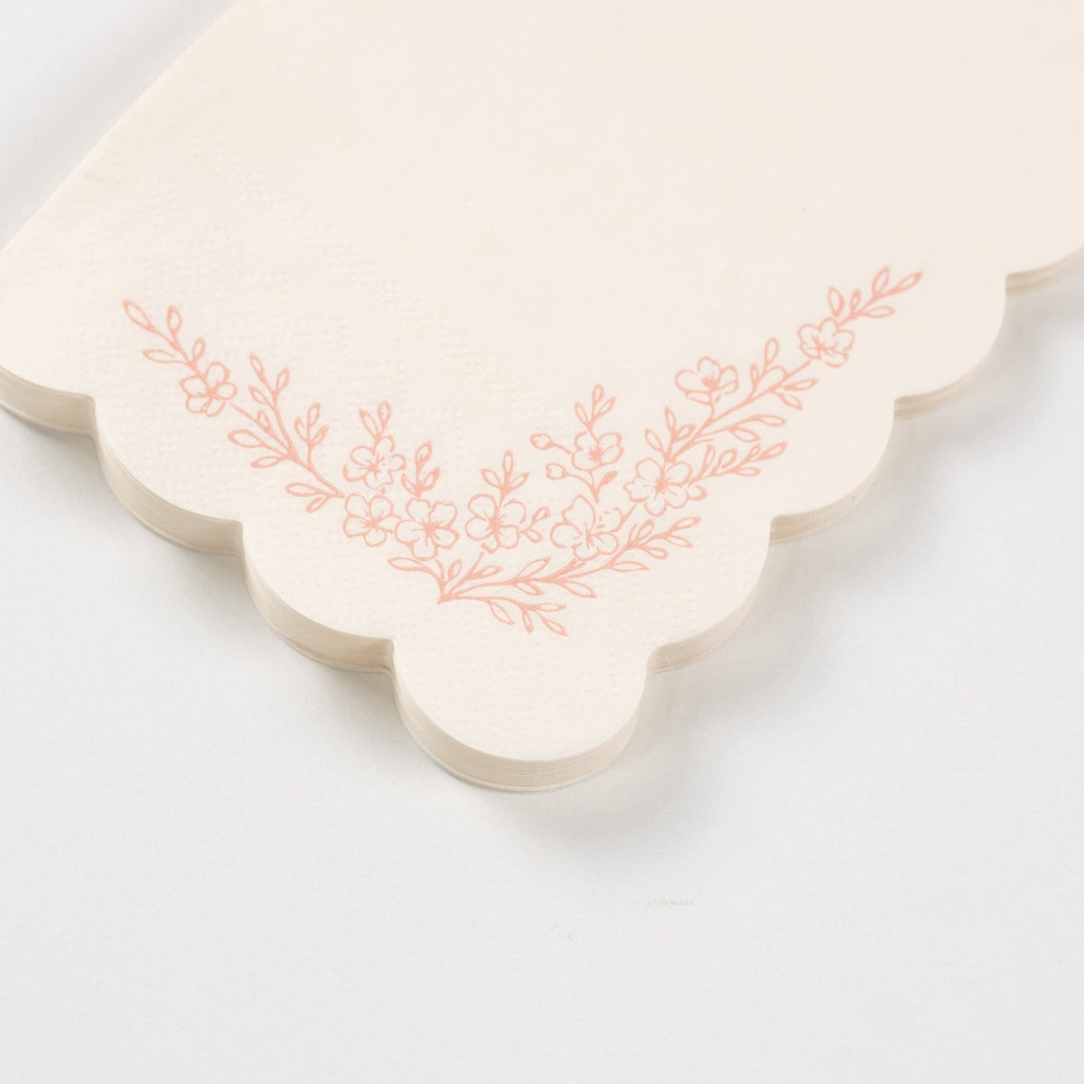 Detailed view of the intricate blush pink floral blossoms and leafy sprigs