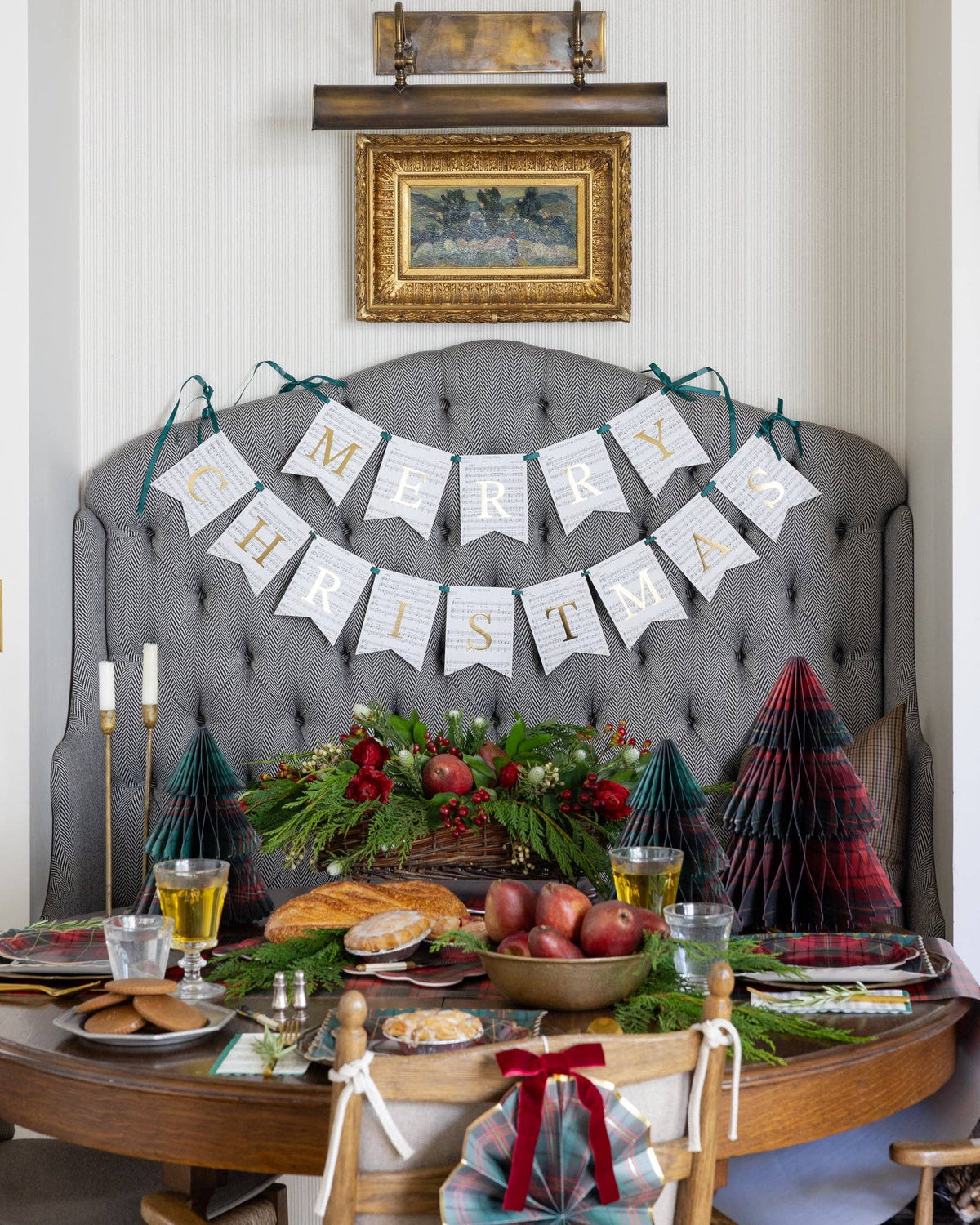 Sheet music Merry Christmas banner styled above a headboard with a holiday table