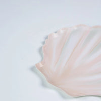partial view of shell party plates showing curved shell design and pastel finish.