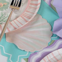shell shaped napkin styled with mermaid party table setting.
