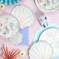 shell shaped paper plates styled with mermaid party table decor.