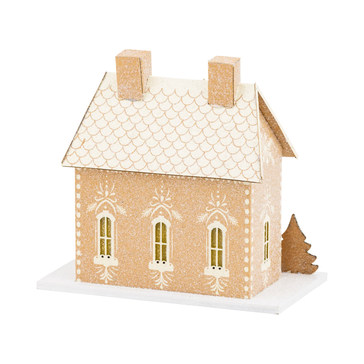 Side view of the lighted Christmas house showing the glittery roof shingles and detailed gingerbread-style window trim.