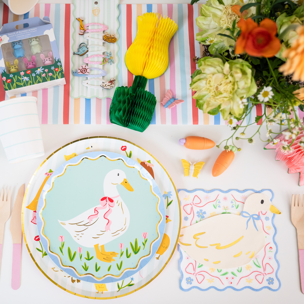 Spring party table featuring goose plates, goose napkins, and pastel table decor.
