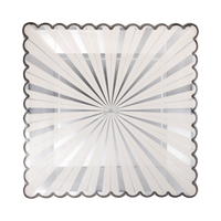 Angled view of the silver starburst square paper dinner plate