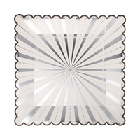 Cream square paper dinner plate with a silver foil starburst design and black scalloped edge
