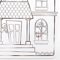 Close up detail of the paper placemat showing a line-art skeleton standing by the haunted house front door and a ghost in the window.
