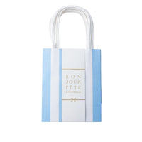 Sky blue cabana stripe paper favor bag with a center label and handles