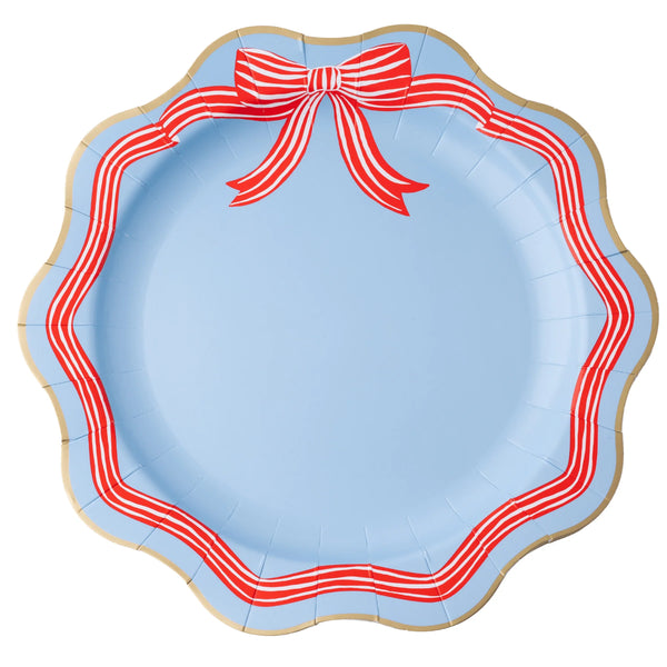 Single sky blue paper dinner plate with a red-and-white striped bow at the top, striped ribbon border, and wavy gold edge.