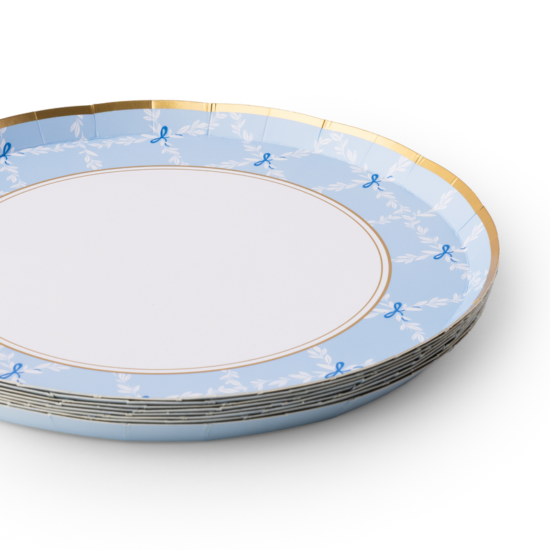 Stack of sky blue trellis plates with gold rim detail