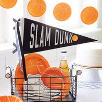 Slam Dunk felt pennant displayed with basketball party decorations and orange plates