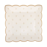 A single paper plate with a tan and cream delicate garden print and gold-foiled scalloped edges.