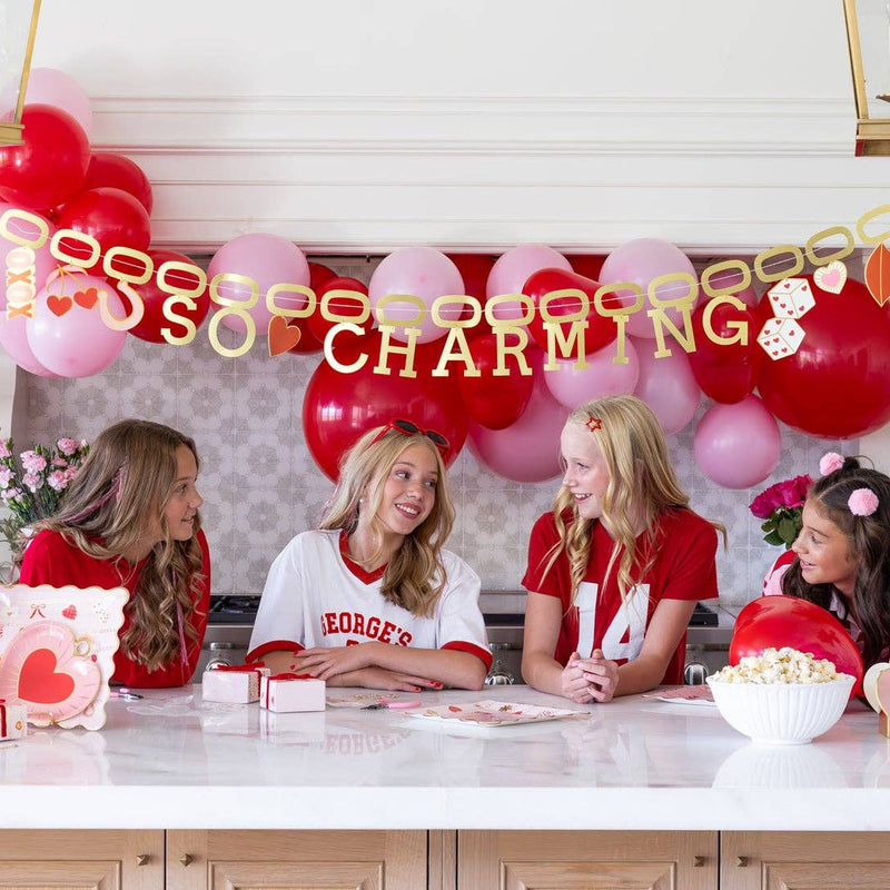 So Charming banner displayed over Valentine’s Day party table