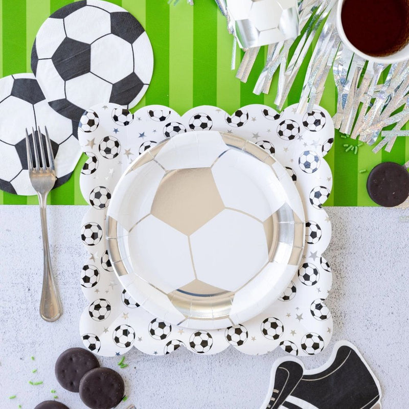 soccer themed party table setup with soccer ball napkins and matching decor.