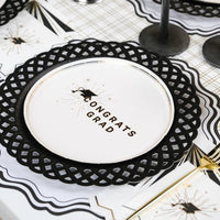 A Congrats Grad plate resting on a black lattice charger for a polished Heritage Graduation Style table.