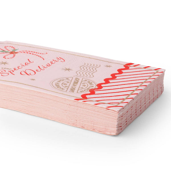 Angled stack of pink gift tag shaped guest towels showing the rickrack candy stripe hem