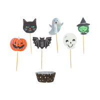 Overhead view of Spooky Friends Halloween cupcake kit showing black baking cups and six die-cut paper toppers including a ghost, cat, pumpkin, bat, witch, and skull. 