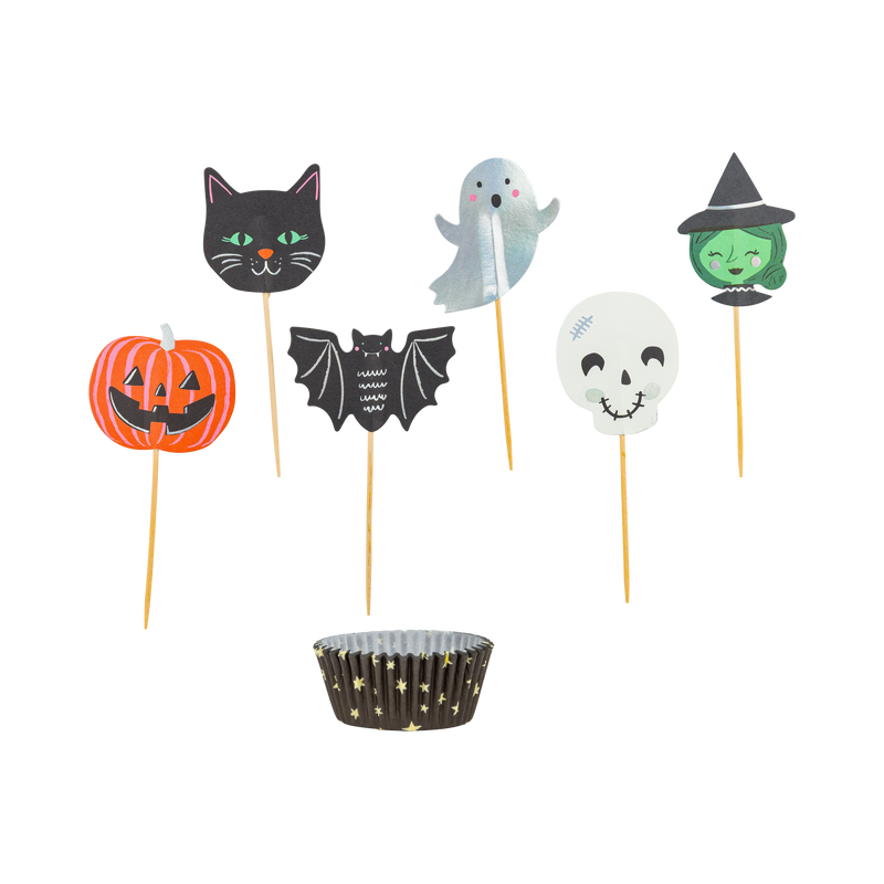 Overhead view of Spooky Friends Halloween cupcake kit showing black baking cups and six die-cut paper toppers including a ghost, cat, pumpkin, bat, witch, and skull. 