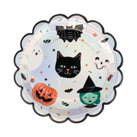 Top-down view of a 9 inch round paper plate featuring vintage Halloween characters and a silver foil scalloped edge on a pastel background.