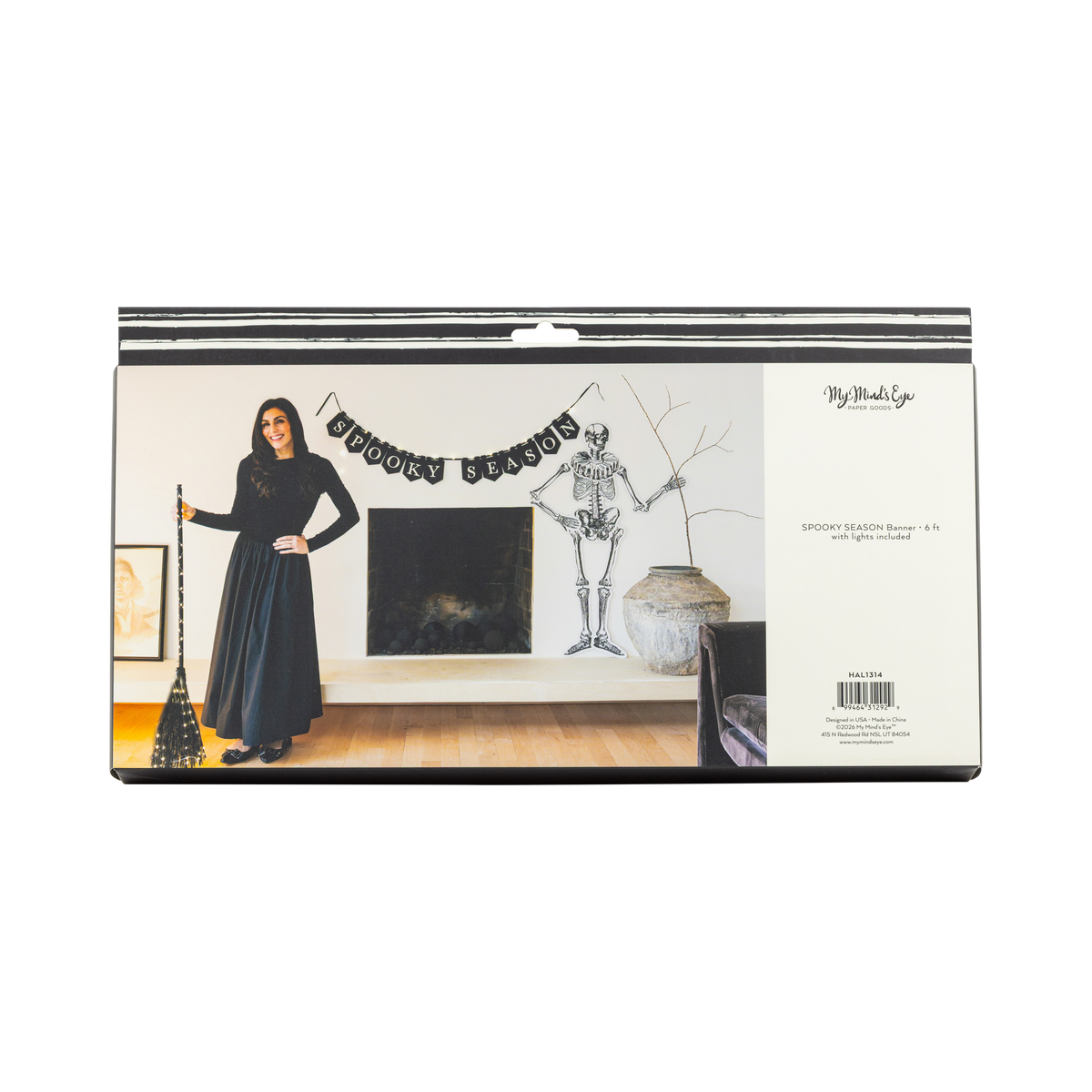 Halloween-themed banner product packaging with a person in a black dress and skeleton decoration.