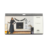 Halloween-themed banner product packaging with a person in a black dress and skeleton decoration.