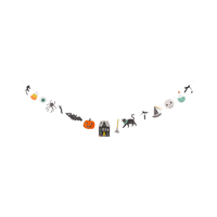 Full character paper banner on white background, hung in a natural drape. All 11 die-cut paper pieces visible left to right: candy corn, blue-green eyeball, black spider, black bat, orange jack-o-lantern, black haunted house with gray roof, broom with orange bristles, black cat with teal collar, dancing figure in party hat, gray skull, and green potion bottle. Cream twine connects all pieces. Black velvet ribbon bows tied between several characters.
