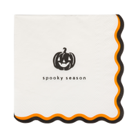 Halloween paper cocktail napkin featuring a smiling jack-o'-lantern and "Spooky Season" design with black and orange wavy edge.