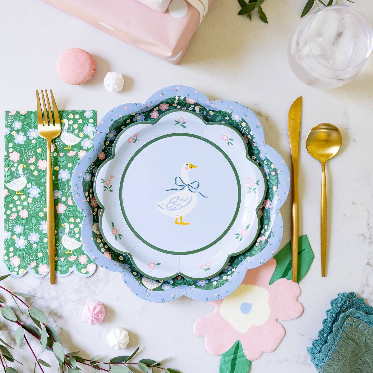 Spring place setting with goose napkin, floral plates, and party details