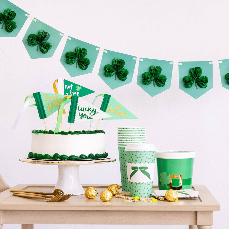 St Patrick’s Day dessert table with honeycomb shamrock banner and green decor