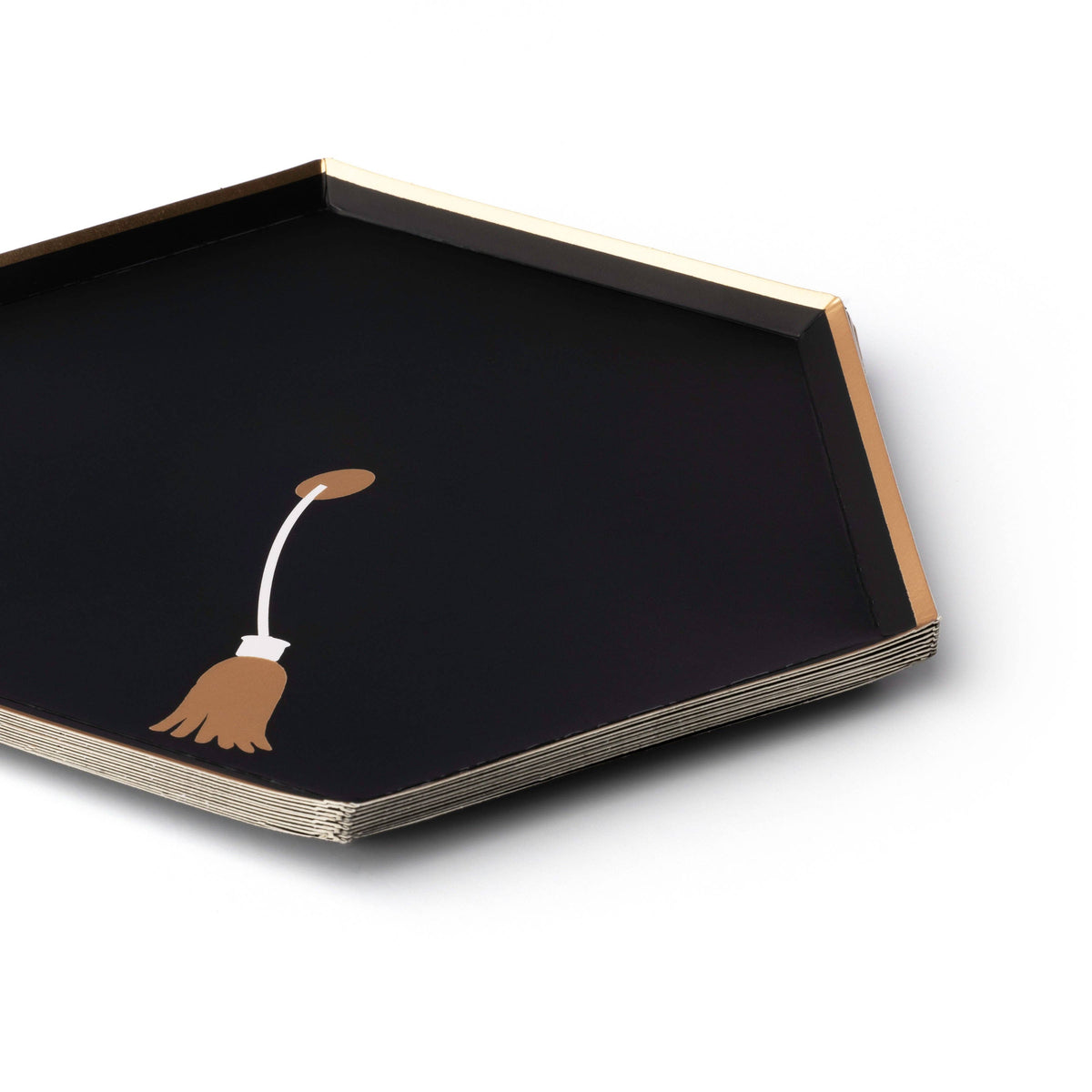 Stack of black hexagon graduation snack plates with gold rim