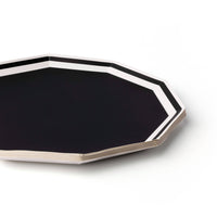 Stack of black and white decagon dinner plates