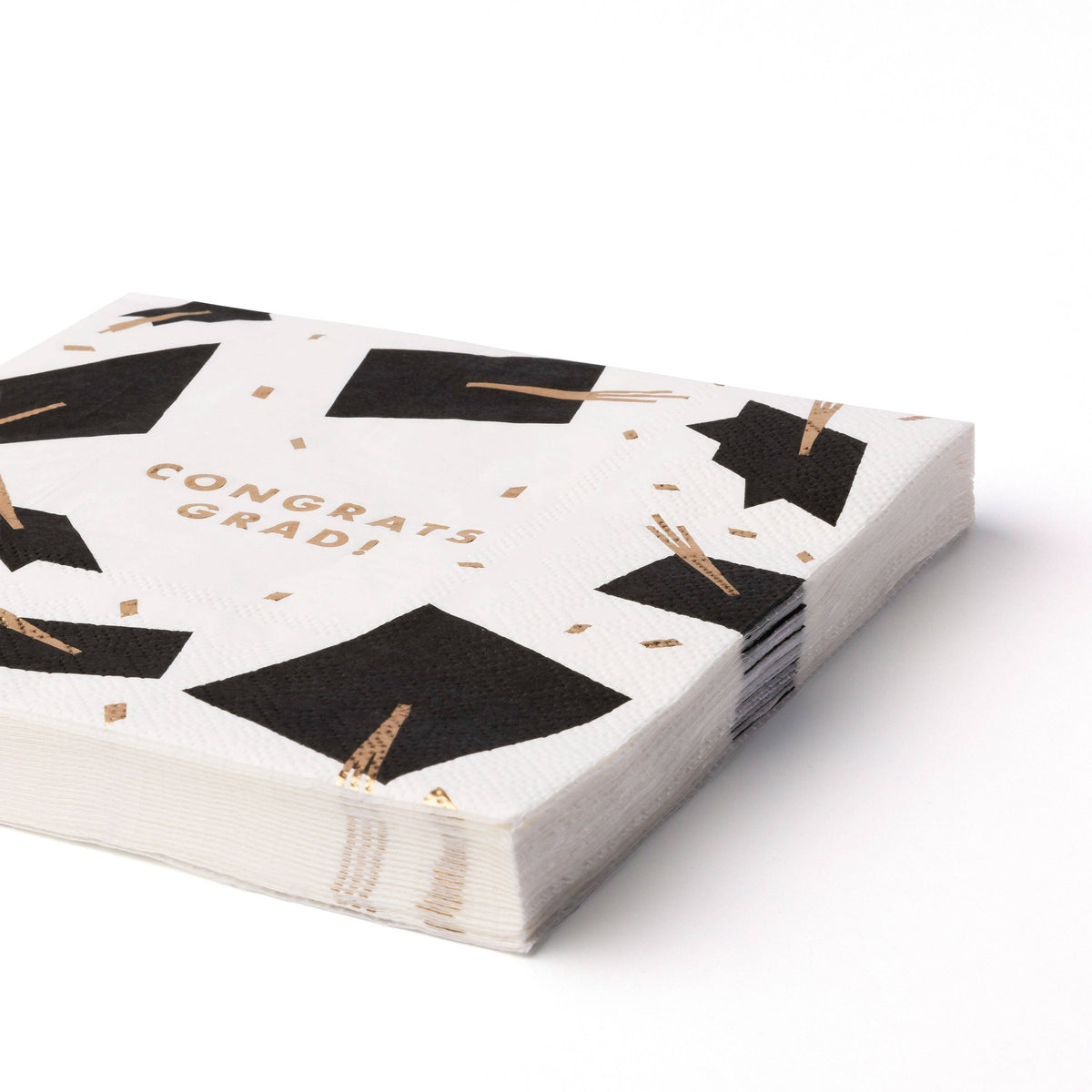 Stack of graduation lunch napkins with black caps and gold foil tassels