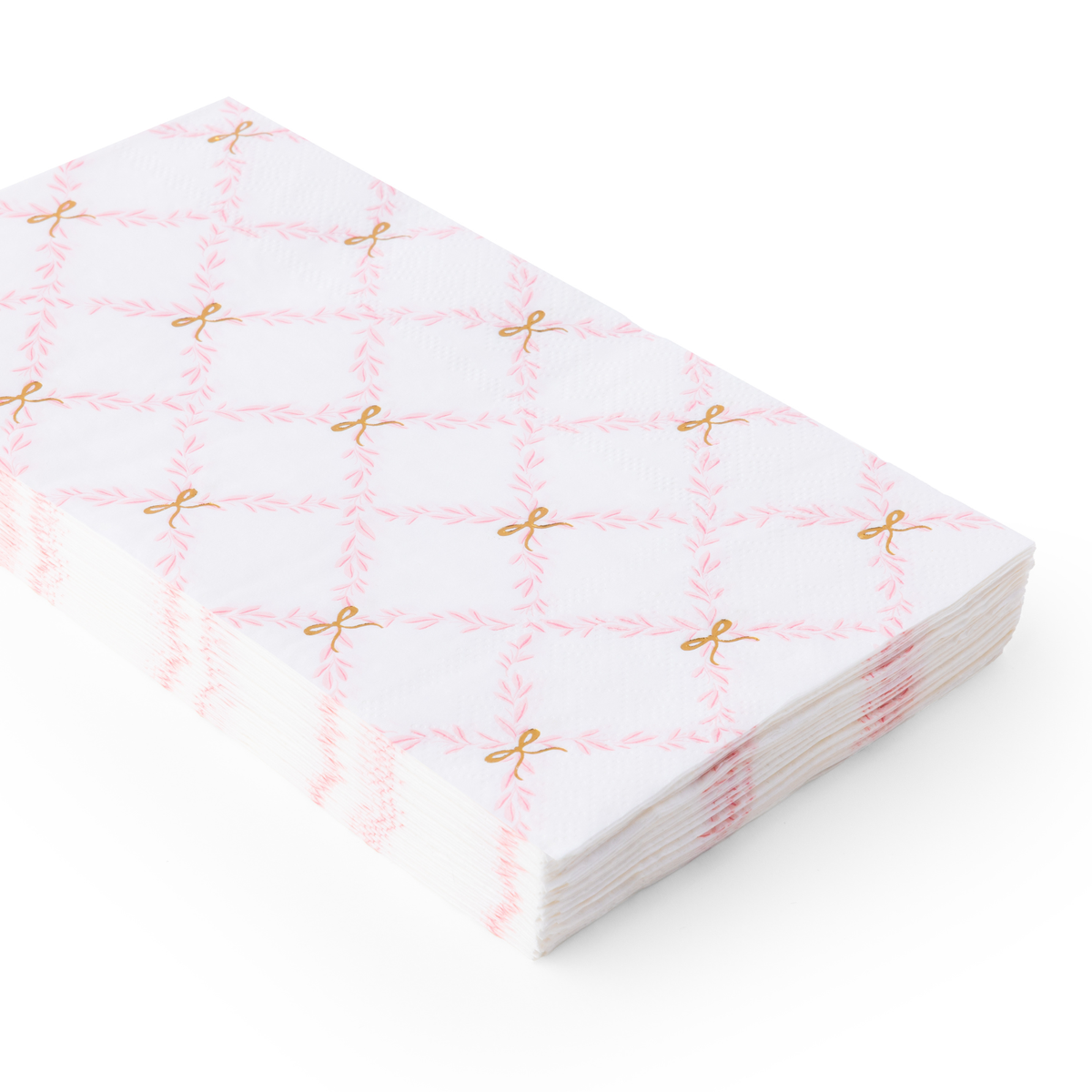Stacked paper guest towels featuring a pink trellis pattern with gold bow details.