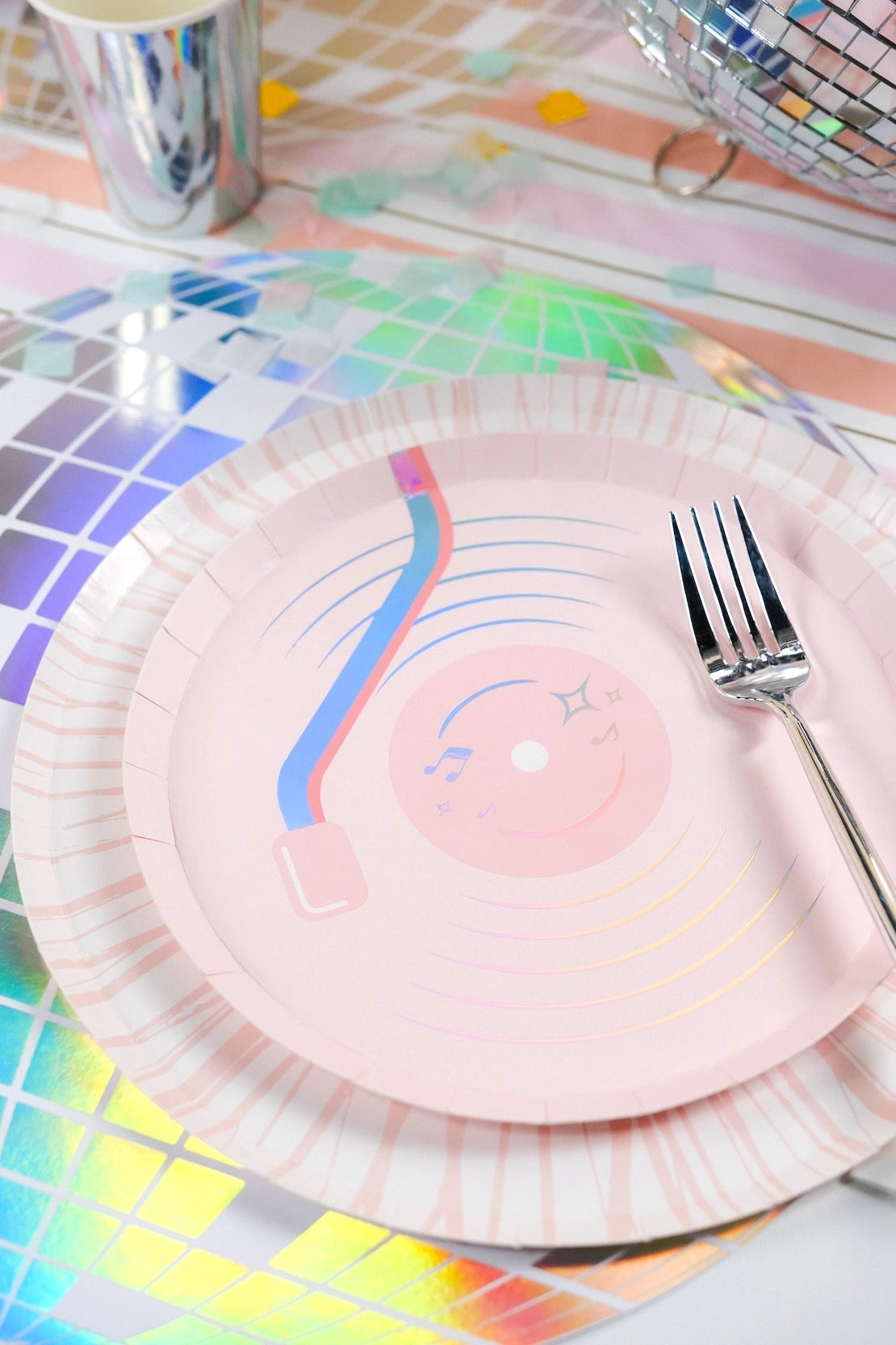 Macro shot of the light-reflecting holographic foil on a disco ball placemat showing the color-shifting effect.