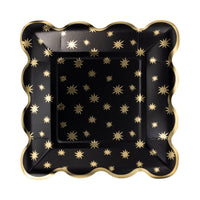 Black square paper plate with gold star pattern and scalloped edges