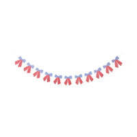 Flat lay of full stars and stripes bow banner on white background showing all eleven paper bows strung on cream twine