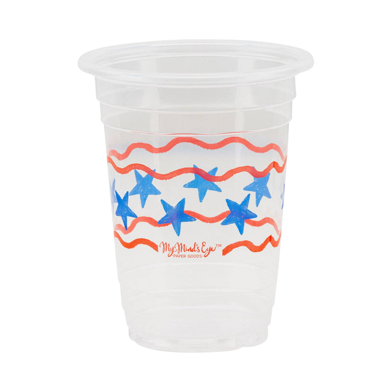 Single clear plastic party cup on white background showing blue star and red wavy stripe design by My Mind's Eye