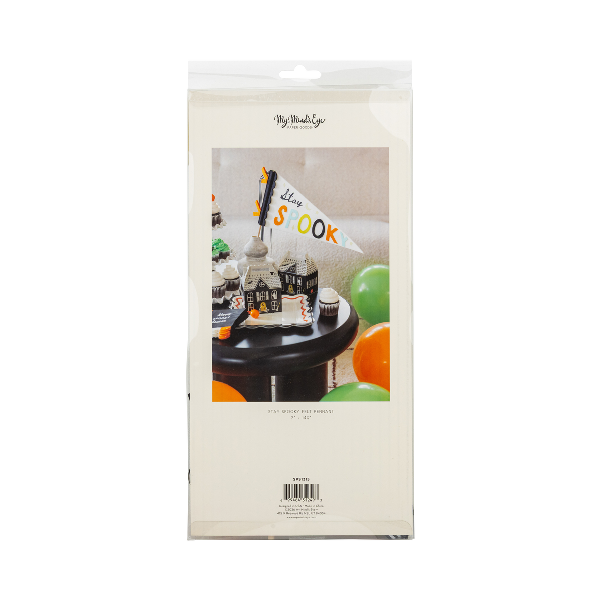Back of the retail package: a cream sleeve with a product label reading "Stay Spooky Felt Pennant • 7" x 14½"" and item number SPS1315, plus a cover photo of the pennant in a vase among haunted house boxes and cupcakes. Straight-on packaging shot.