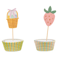 A pink strawberry and a yellow Easter basket cupcake topper on wooden picks, essential spring party supplies for holiday baking.