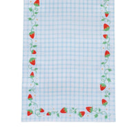 Close-up corner of the strawberry gingham table runner showing red berries, curling green vines, and tiny gold stars along the blue gingham edge.