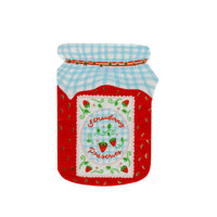 Single strawberry jam jar shaped die-cut paper cocktail napkin on a white background showing the blue gingham lid with red-and-gold star band, red jar body with gold strawberry seed accents, and scalloped white center label reading "Strawberry Preserves" in red script