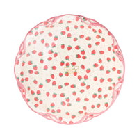 Top-down view of stack of Strawberry Scalloped Paper Dinner Plates showing cream background with all-over red strawberry print with green stems and tiny pink polka dots, finished with a pink scalloped flower-shaped edge