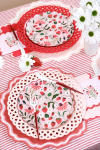 Overhead view of a full Summer Picnic Flat-Lay featuring multiple Strawberry Paper Plates and floral accents.