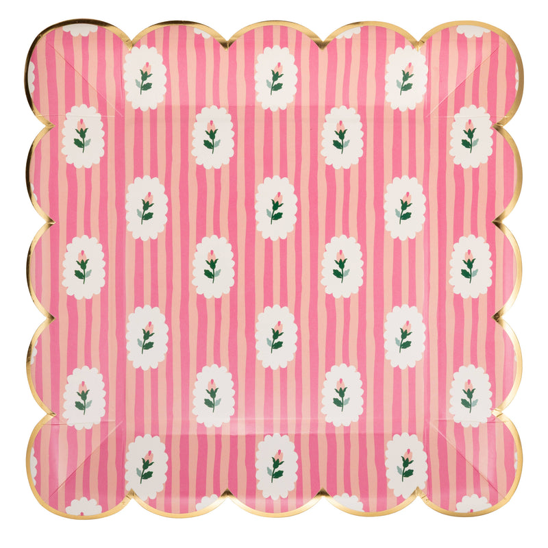 Pink striped floral paper plate with gold scalloped edge on white background