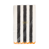 Striped paper napkin with black and white stripes and orange trim on a clear packaging.