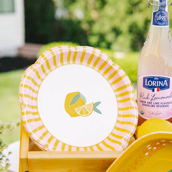 Lemon themed party table with striped scallop plate display