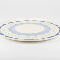 Side profile of a flat blue coquette plate showing durable construction